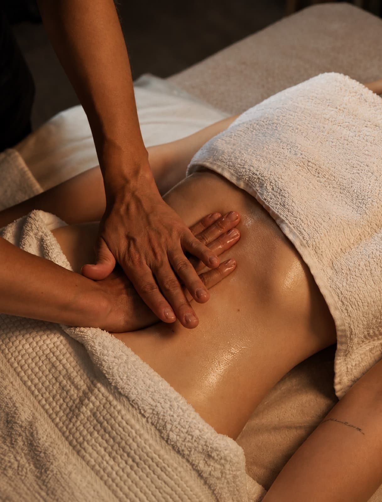 Hands-on womb and abdominal bodywork during a Whole Womban Healing session