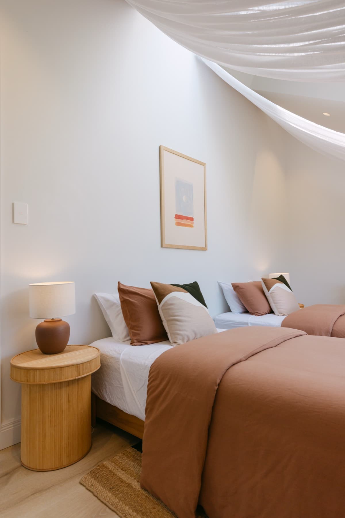 The Maukatia Bay Room at Kula Muriwai, twin king single beds beneath a skylight