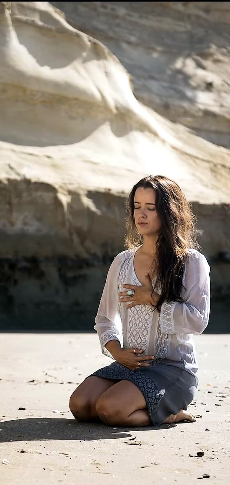 Sophia holding a crystal to her heart