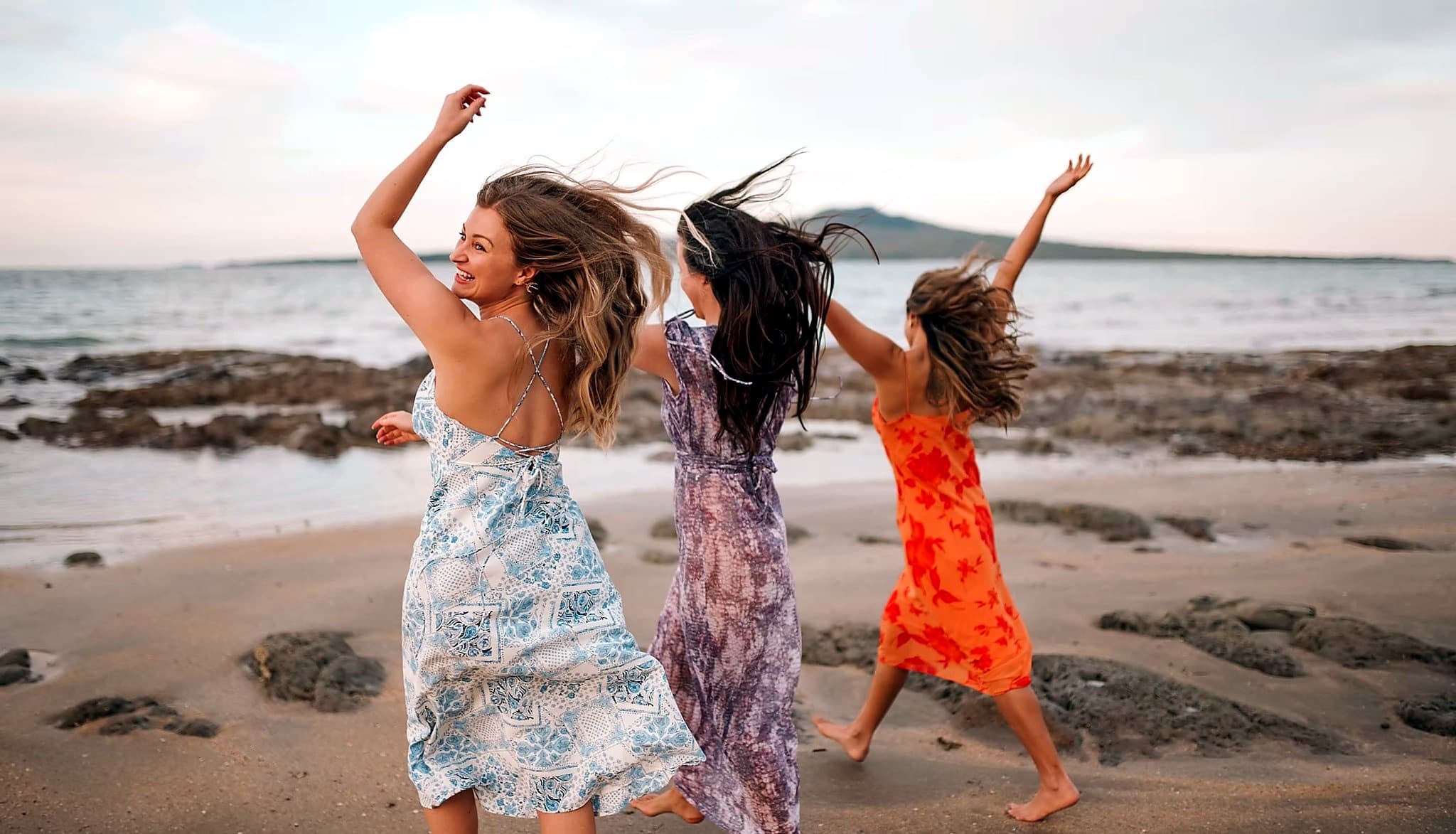 Women dancing freely on the beach